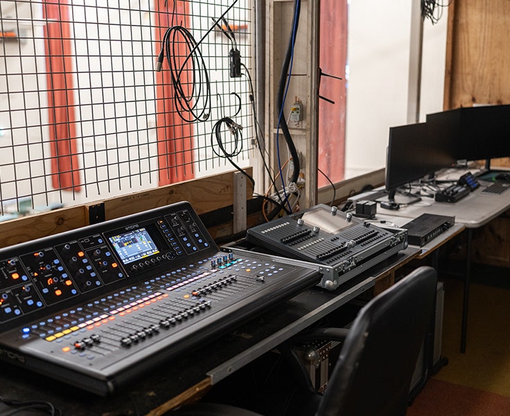 Image of our VET Entertainment workspace in the school hall including sound and lighting consoles.