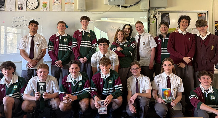 Image of one of our senior English classes as they hold up the books they have been reading and/or studying.