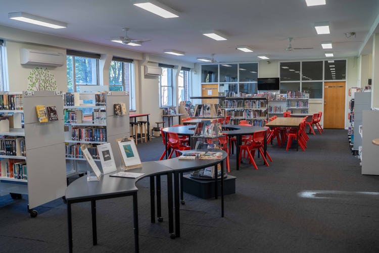 An image of our school library with books and an area for students to study.