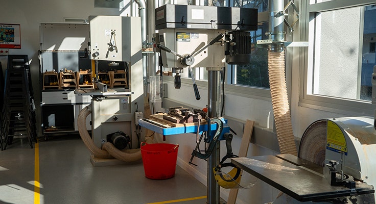 An image of one of our TAS wood workshops with a drill press in centre of frame