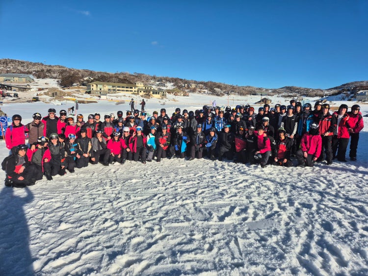 Image of our Year 10 students in a group on the snow fields smiling for the camera.