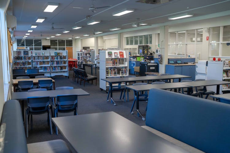 An image of our school library with books and an area for students to study.