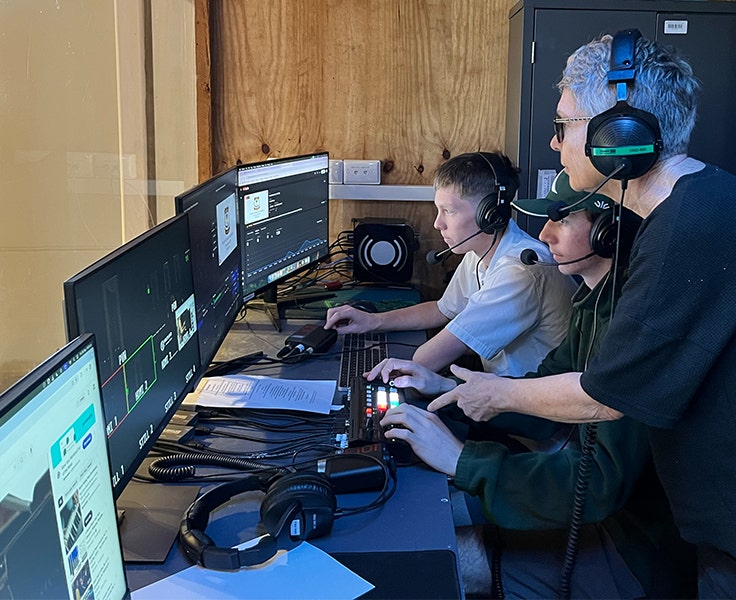 Two of our VET Entertainment students operating our assembly live-stream and being directed by one of our teachers. All are wearing headsets to communicate.